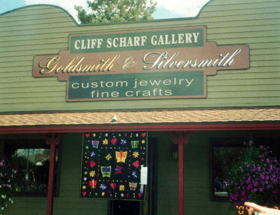A scanned photograph of a jewellery shop with a quilt hanging with butterflies