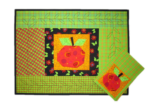 Decorative placemat with a red apple design on a green background