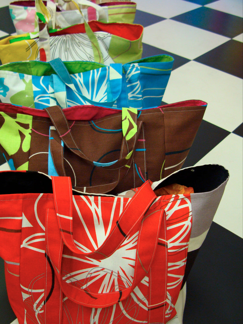 Colorful fabric bags arranged on a checkered floor