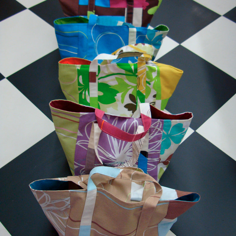 Colorful shopping bags arranged on a checkered floor