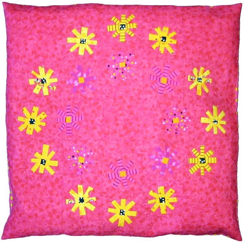 Pink pillow with yellow flower patterns on a pink background