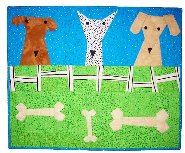 Children's quilt with cartoon dogs and bones on a blue and green background