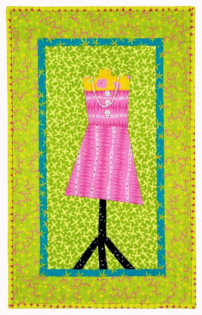 Colorful quilt design. Pink dress on a mannequin against a green background