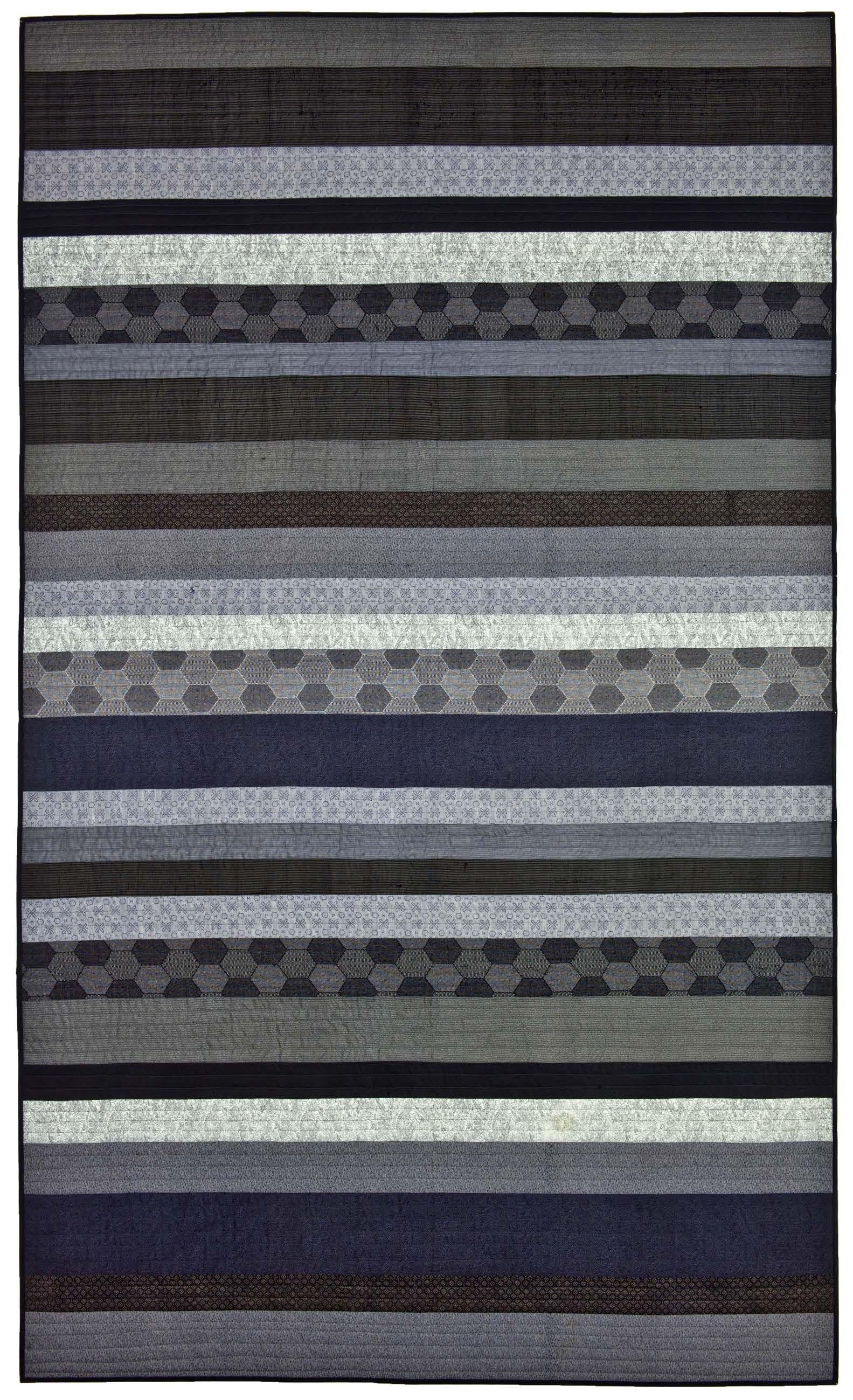 Rectangular rug with horizontal striped pattern in various shades of gray and black on a white background