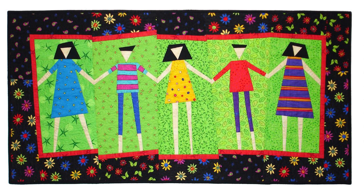 Colorful quilt with five stylized figures holding hands on a green background.