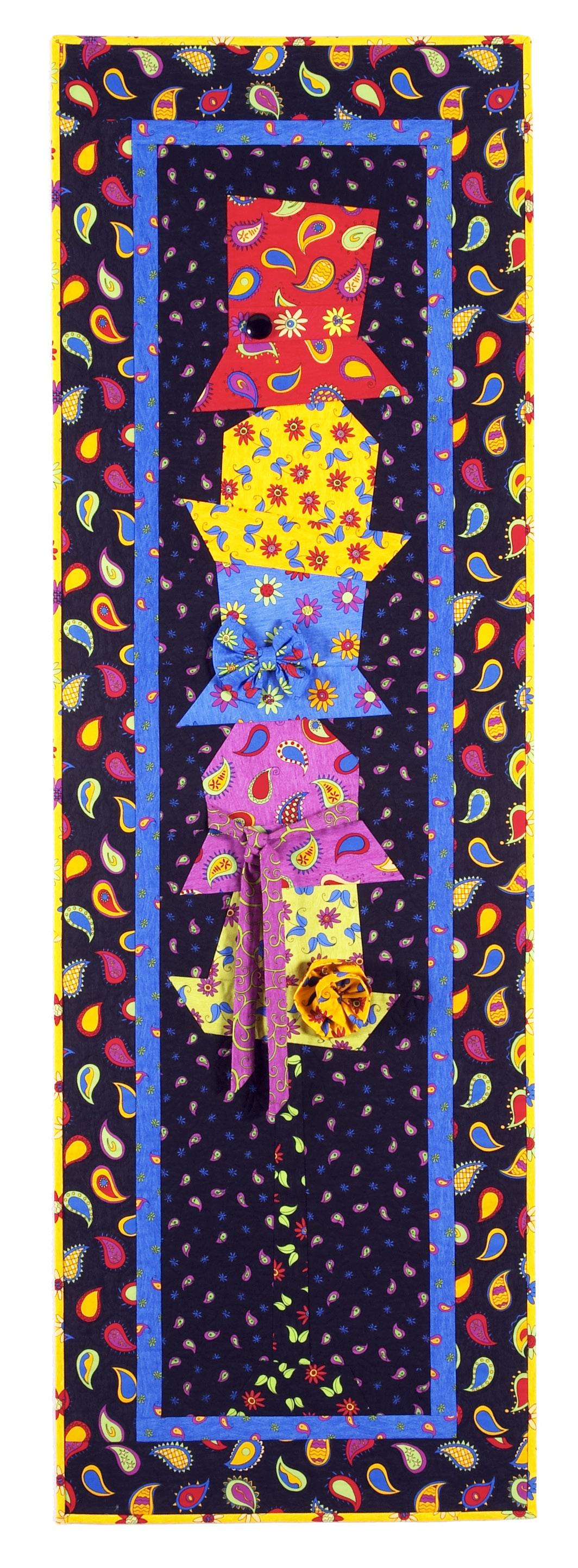 Colorful quilt with a pattern of tall, colorful hats on a dark background