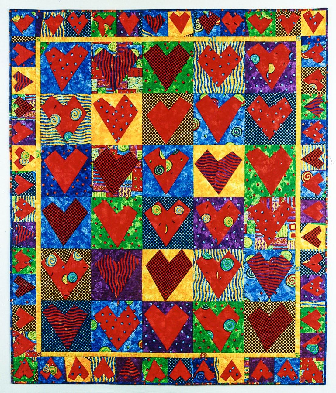 Colorful quilt with red heart patterns on a multicolored background