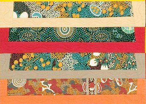 Quilt design of colorful patterned strips with various indigenous Australian designs 