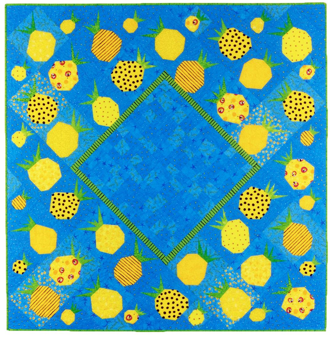 Quilt with pineapple pattern on a blue background