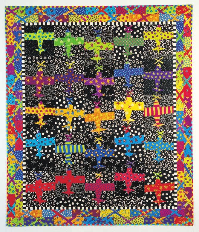 Colorful quilt with airplane pattern on a black background