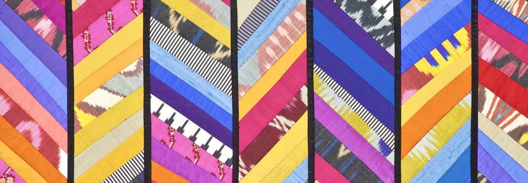 Colorful patterned abstract quilt arranged in a grid.