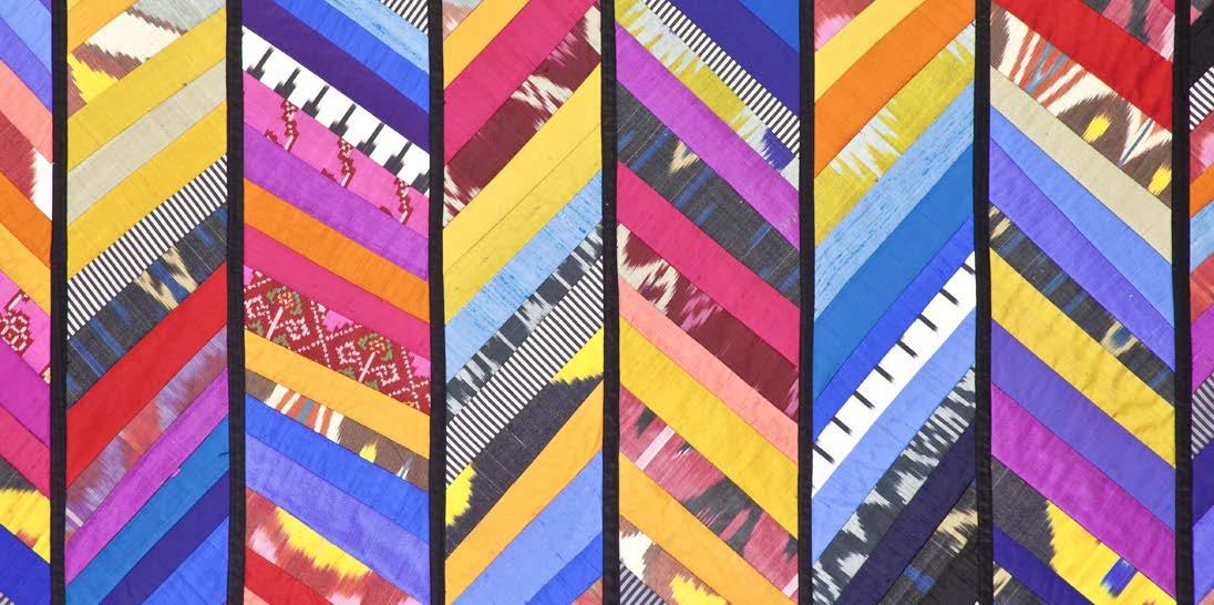 Close up of stripey colourful abstract quilt