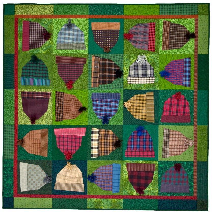 Quilt with pattern of plaid hats on a green background