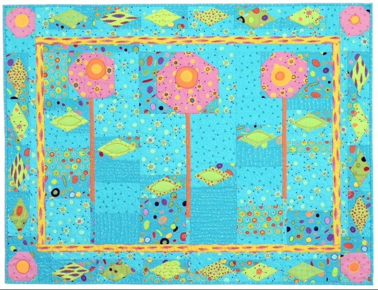 Pink tall flowers on a blue patterned background quilt with green leaves